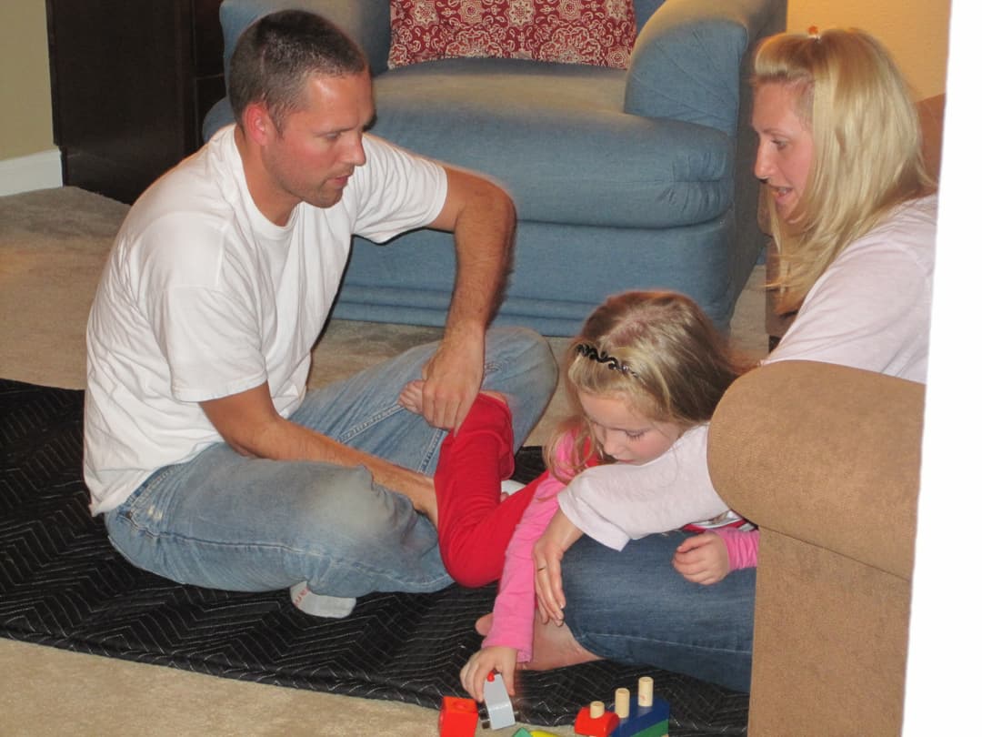 Functional Synthesis session — practitioner and child exploring movement through play with mother present