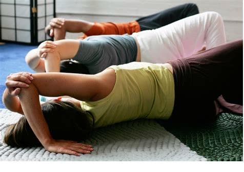Anat Baniel Method group class — students practicing gentle floor movements